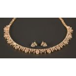 A gold and diamond set collar necklace, the front designed as a series of drops alternating with