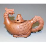 A Chinese Yixing stoneware phoenix teapot and cover, modelled as a seated phoenix with tail