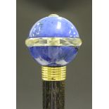 A late Victorian ebony walking cane, the lapis lazuli circular pommel divided by a cross section