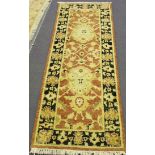 An Afghan Ziegler style runner, modern, the terracotta field with bold palmettes, within a