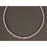 An 18ct white gold and diamond necklace, claw set with circular cut diamonds graduating in size to