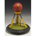 An early 20th Century boxwood cricket award, formed as three miniature cricket bats above a set of