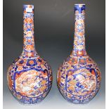 A pair of Japanese Imari porcelain bottle vases, Meiji period, each painted with birds and