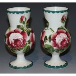 A pair of Wemyss pottery vases, early 20th Century, of thistle form painted with pink cabbage