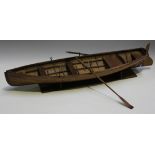 A 19th Century oak clinker built model of a rowing boat with hinged rudder and a pair of matching