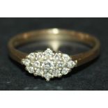 A 9ct gold and diamond set lozenge shaped cluster ring, mounted with circular cut diamonds with