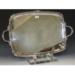 A late Victorian plated two handled tray, the centre engraved with a coat of arms within a scallop