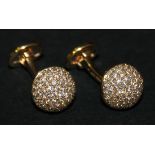 A pair of 18ct gold and diamond set dress cufflinks, each with a hemispherical front, pavé set