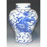 A Chinese blue and white porcelain vase, Kangxi period, the baluster body painted with three playful