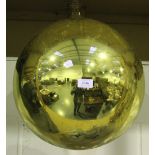 A large gold mirrored glass witch ball, diameter approx 38cm, together with a similar smaller