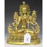 A Sino-Tibetan gilt bronze figure of Tara, modelled seated in dhyanasana, her headdress and