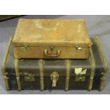 An early 20th Century wooden bound travelling trunk and three brown leather suitcases.