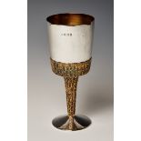 A silver and parcel gilt goblet, the bucket shaped bowl with textured gilt base and tapering stem,
