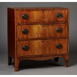 A George III mahogany chest of three long drawers with ebony line inlaid borders, on bracket feet,