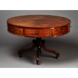 A George III mahogany drum top library table, the circular top with an ebony line inlaid border
