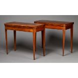 A pair of late George III rosewood fold-over card tables with overall crossbanded borders, the