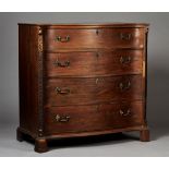A George III mahogany serpentine fronted chest of four graduated long drawers with applied gilt cast