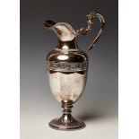 A late 20th Century French silver claret jug, the urn shaped body decorated in relief with an