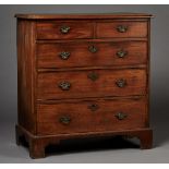 A George III oak chest of two short and three long drawers with applied brass drop handles, on
