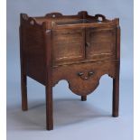 A George III mahogany night cupboard, the pierced gallery top above a pair of panelled doors and a