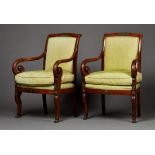 A pair of 19th Century French Empire style mahogany framed armchairs with applied gilt metal swan,
