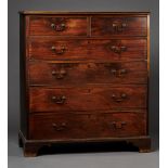 A George III mahogany chest of two short and four long drawers with applied brass drop handles, on