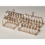 A pair of silver six division toast racks, each of arched form with pierced handle, Birmingham