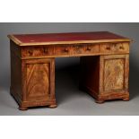 A George IV figured mahogany twin pedestal desk, the moulded top inset with red leather above an