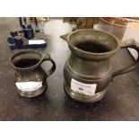 2 old pewter measuring jugs.