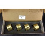 A boxed set of 4 heavy brass napkin rings ' Devon' pattern by Baldwin U.S.A.