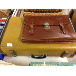 A vintage suitcase with a leather briefcase.