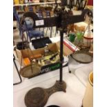 Victorian cast iron balance scales with brass pans. Bears an official calibration stamp showing a