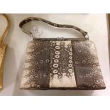 A vintage snakeskin effect ladies handbag.