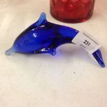 A Bristol blue glass dolphin paperweight.