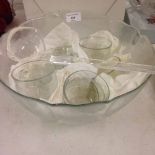 A glass punch bowl, 6 cups and ladle.