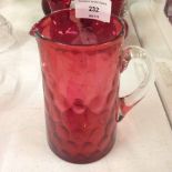 A Victorian hand blown Cranberry glass jug with pontil mark