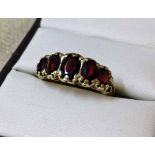 A 9ct gold Victorian ring set with 5 oval garnets, size N