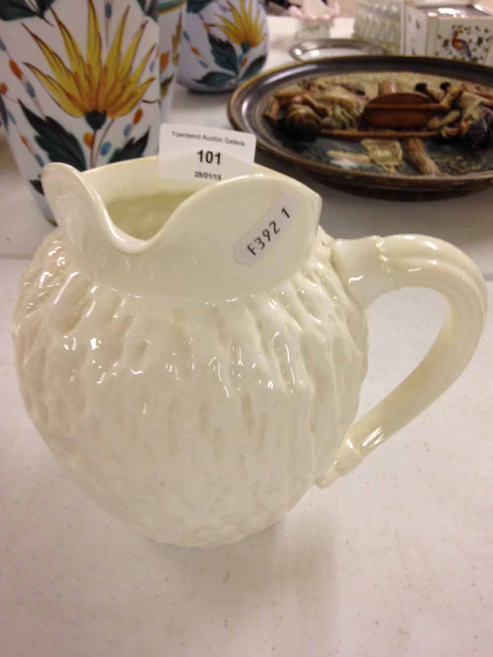 A 19th century Coalport blanc de chine side handled jug with bark design.