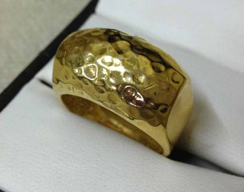 A heavy 925 silver, yellow gold plated ring with beaten metal effect, size P