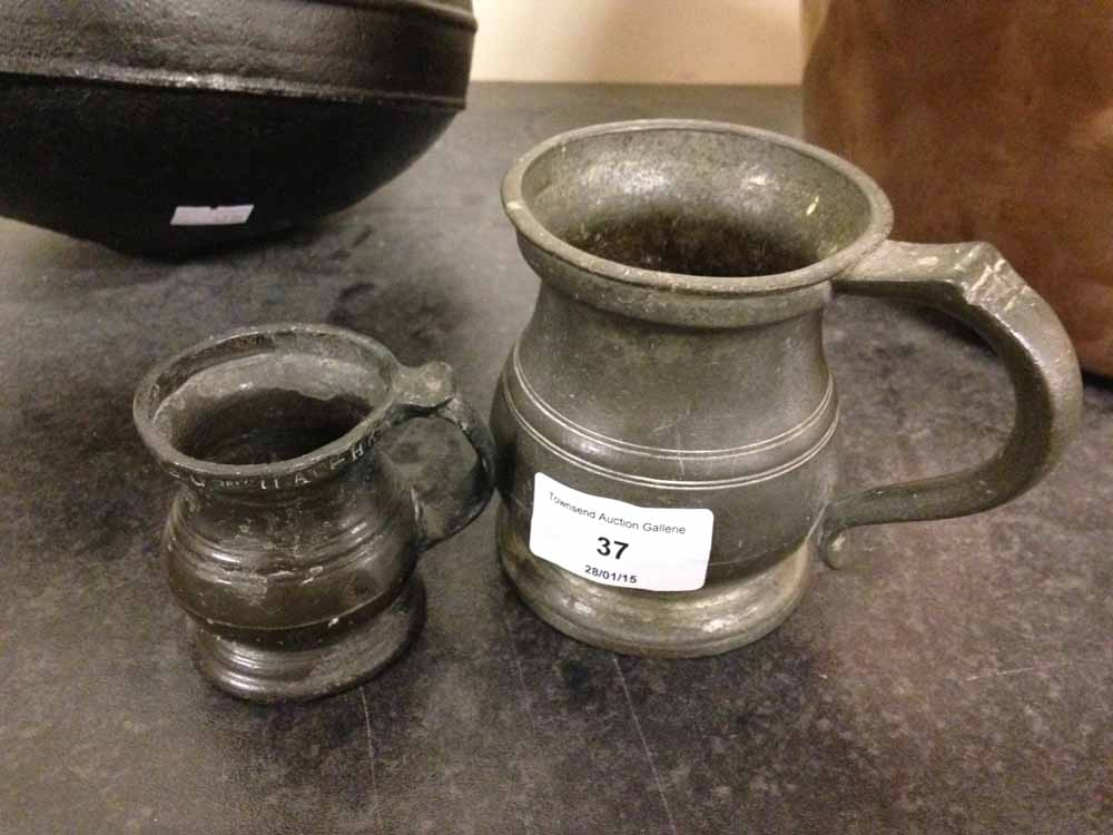 2 old pewter measuring jugs.