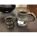 2 old pewter measuring jugs.