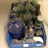 A box of old glass bottles of mixed sized.