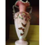 An antique French enamelled glass vase with butterfly decoration 33cm tall.