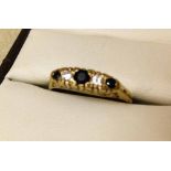 A ladies 9ct gold sapphire and diamond ring. 3 sapphires and 2 diamonds - size N.