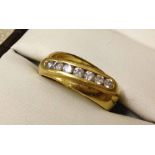 A ladies 18ct gold and diamond ring - modern style set with 7 diamonds. Total carat weight .33ct.