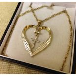 Silver & gold plated open heart with cross inside, on a silver chain.  Engraved with a religious
