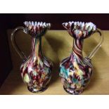 A pair of antique Victorian glass multi coloured ewers.