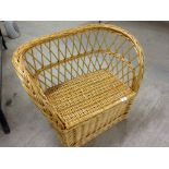 Childs wicker seat with storage, 69cm wide x 53cm tall.