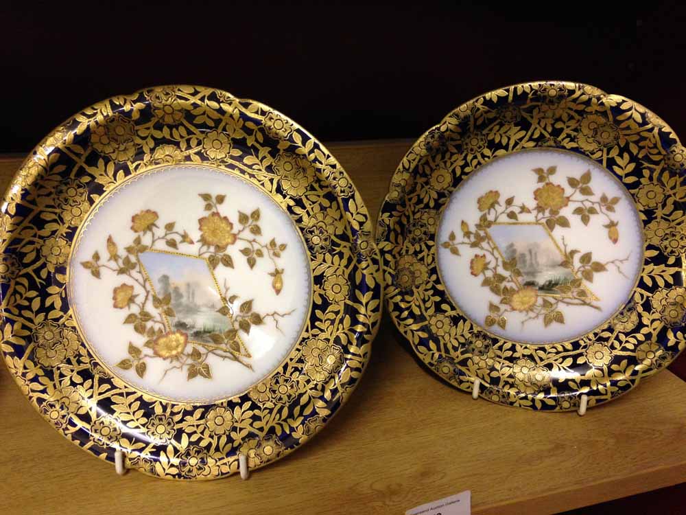 A pair of antique Limoges hand painted & gilt cabinet plates with landscape scenes