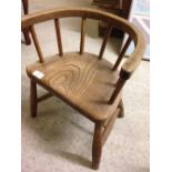 A vintage child's curved stick back oak chair